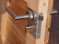 Edelstahldrückergarnitur an Tür mit waagerechter Rhombusschalung aus Holz für das Gartenhaus KLARE LINIE